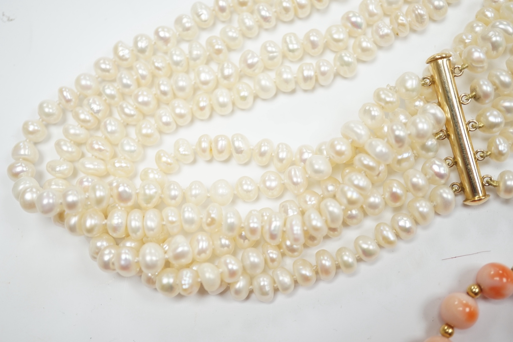 A modern five strand baroque pearl choker necklace with 14k clasp, 36cm, a single strand cultured pearl necklace, with gem set yellow metal clasp, a modern single strand coral bead necklace, two coral branch necklaces an